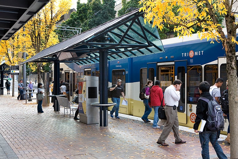 Riders board a MAX light rail train at SW Sixth and Montgomery avenues in downtown Portland. Photo courtesy of TriMet.