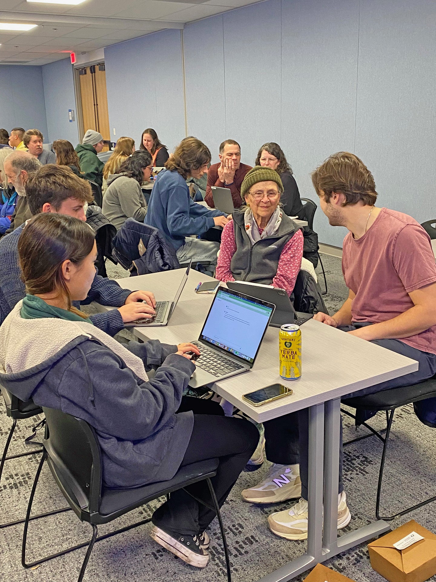 Photograph of another group of students interacting with Salem citizens at the AI presentation.