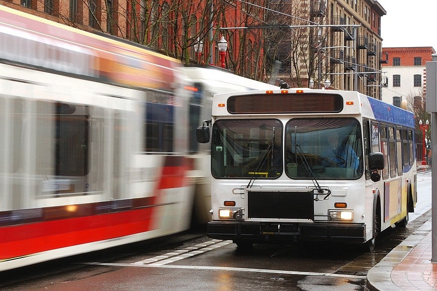 Photograph of a bus and a tram in Portland. 