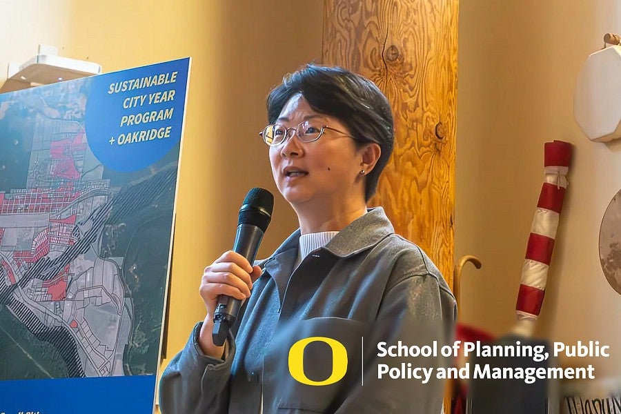 Photograph of Yizhao Yang presenting their courses to the SCYP luncheon. 