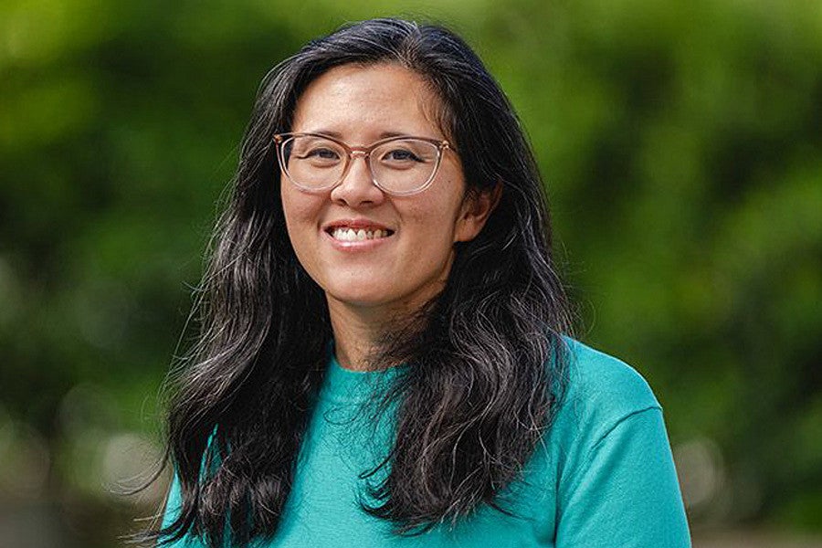 Nicole Ngo news header for research story. Shows a portrait of a woman in front of a blurry green background. Decorative. 