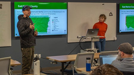 Two students present their midterm projects to the class. 