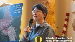 Photograph of Yizhao Yang presenting their courses to the SCYP luncheon. 