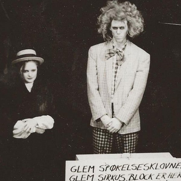 black and white photo of two people with sign