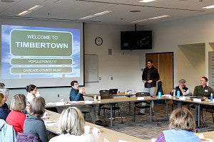 Photo of a presentation and people in a room