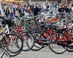 a large number of bicycles parked in a courtyard