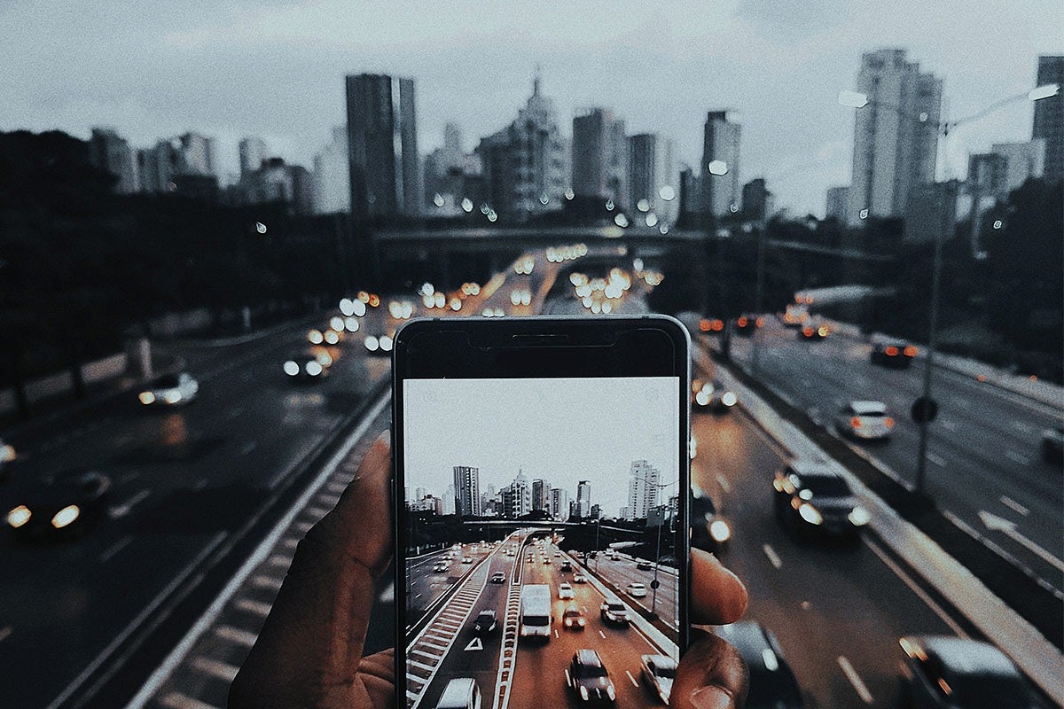 Photo of a phone overlooking a cityscape and traffic