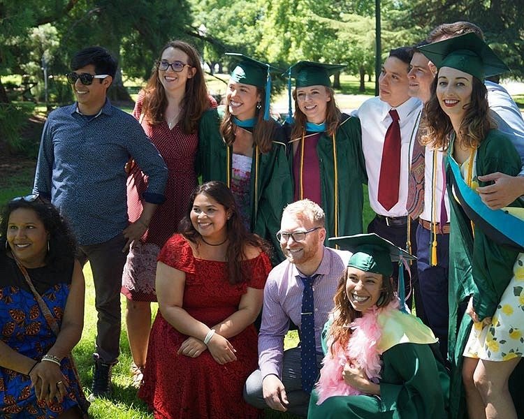 students pose for a photo at graduation