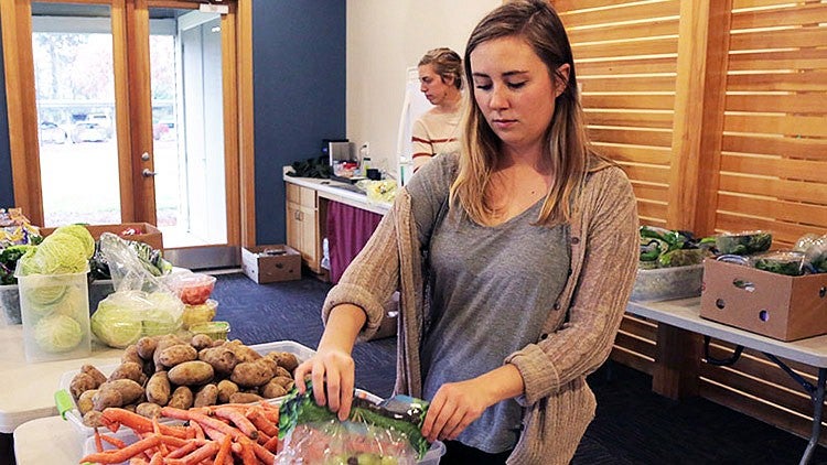 student prepares vegetables