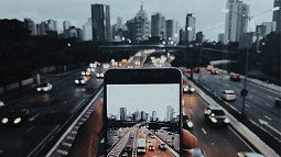 Photo of a phone overlooking a cityscape