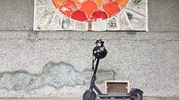 E-scooter in front of ceramic mural