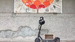 E-scooter in front of ceramic mural