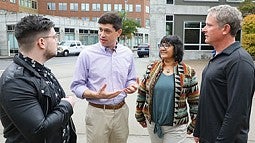 Group of four people standing on street