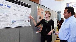 student presents work to Gerardo Sandoval