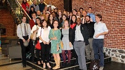 students pose for a photo on steps