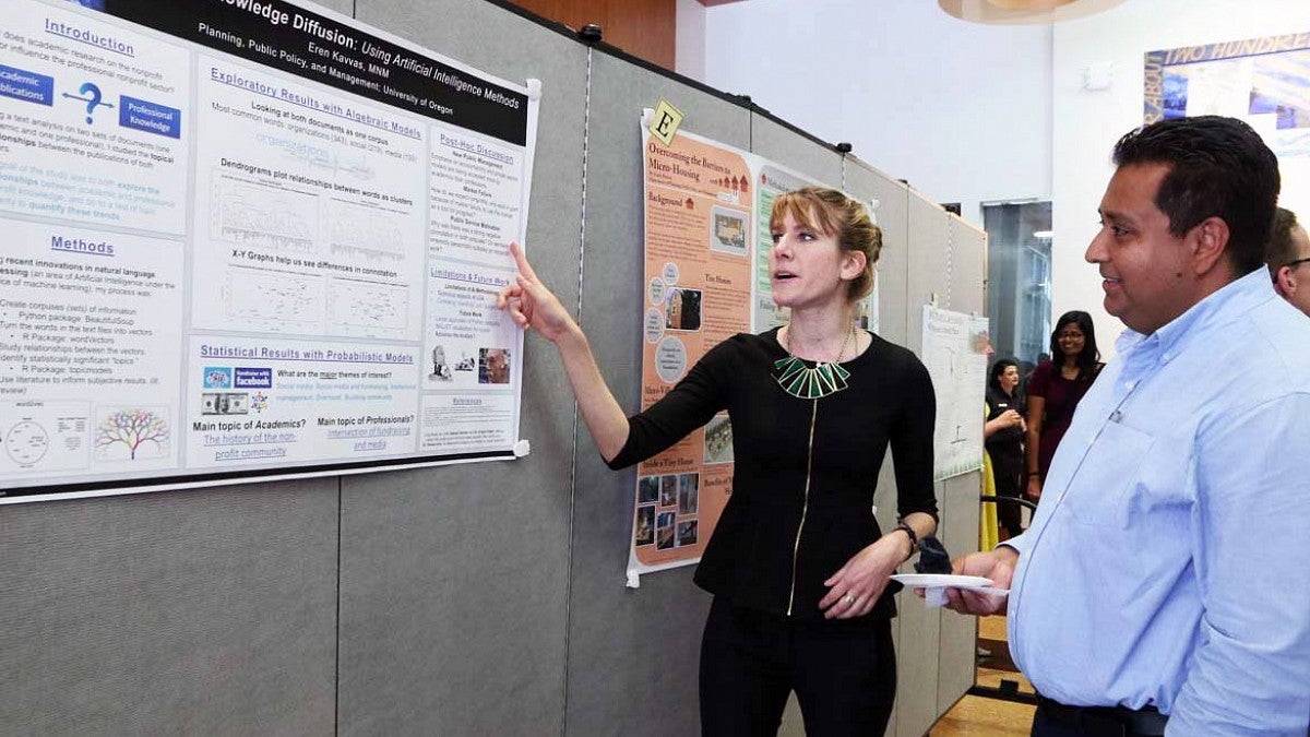 student presents work to Gerardo Sandoval